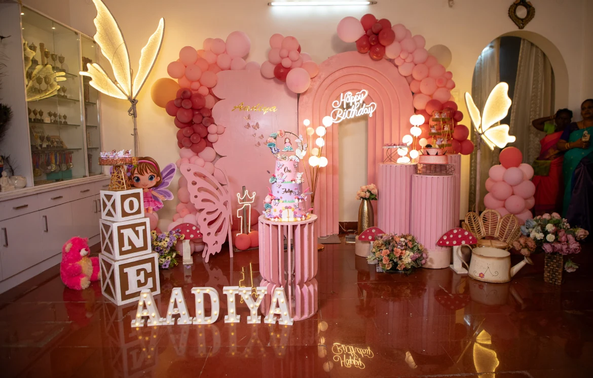 Pink fairy birthday decorations with butterflies and a tiered cake