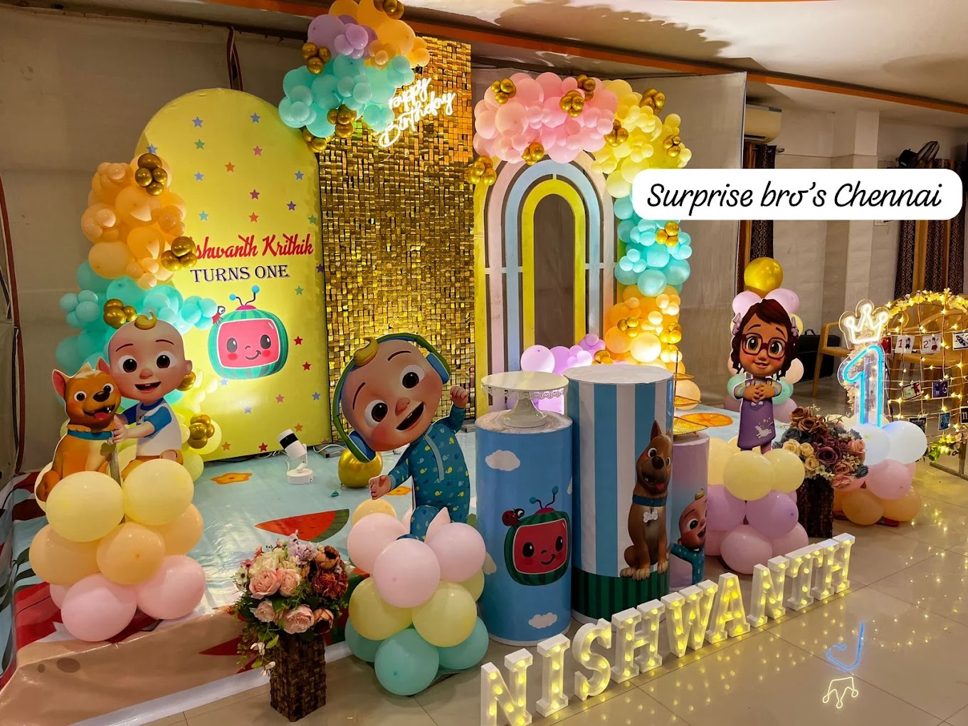 Pastel cartoon birthday stage with a gold sequin backdrop
