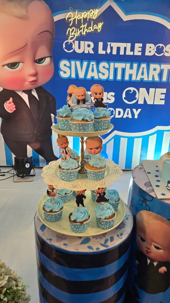 Blue Boss Baby cupcakes on a three-tier birthday display