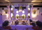 Small photograph of a purple and white decorated event stage